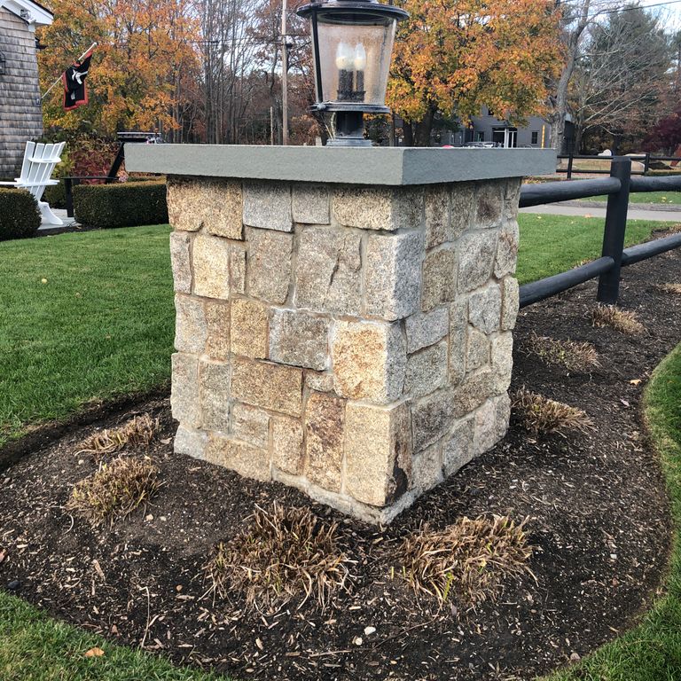 Application image for Cape Neddick Granite Clear - Full Bed Veneer. The image shows this product being used in a full bed veneer application. The surface finish shown is rockfaced. Dominant colors shown are brown and gray. Regular color pattern.