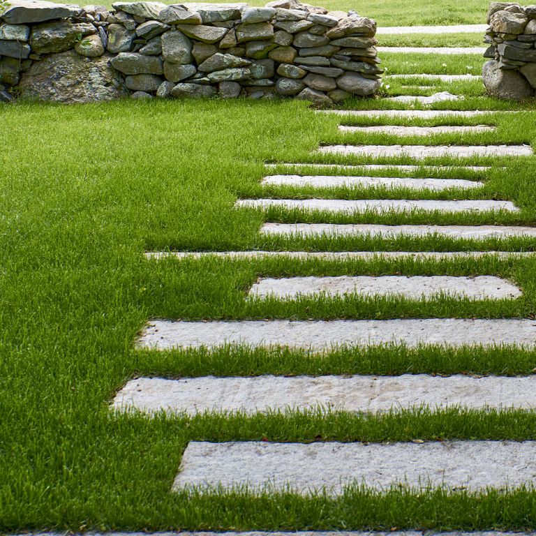 Application image for Reclaimed First Generation Granite Curbstone - Steppers. The image shows this product being used in a path pavers application. The surface finish shown is . The dominant color shown is gray. The color mix creates a warm feeling. Regular color pattern.