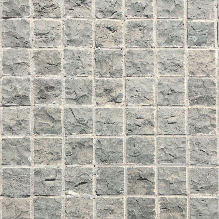 Close-up image for Ankar Gray Basalt - Cobblestones. The surface finish shown is split-face with flat plane. Dominant colors shown are beige and gray; with pink, white, tan and cream secondaries. Exhibits 