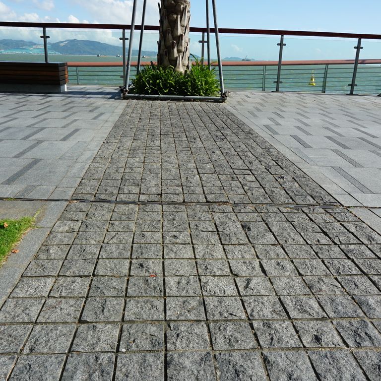 Feature image for Basalt - Ankar Gray - Cobblestones. The image shows this product being used in a public area application. The dominant color shown is gray. Exhibits 