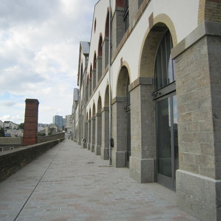 Application image for Granite - Masterpiece Yellow - Pavers. The image shows this product being used in a public area application. The dominant color shown is gray.