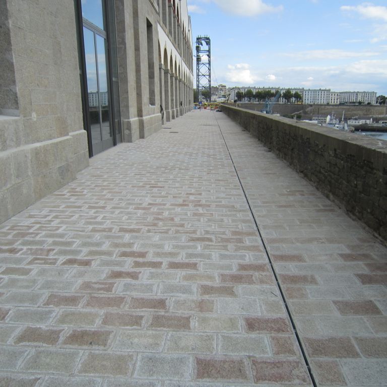 The image shows this product being used for driveway pavers, path pavers and patio pavers.