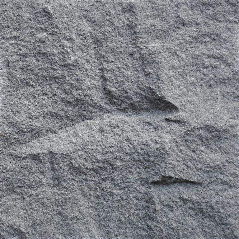 Swatch image cropped for Ankar Gray Basalt - Split Veneer. The surface finish shown is split-face with rough plane. The dominant color shown is gray. The color mix creates a cool feeling. Regular and fine speckled color patterns.