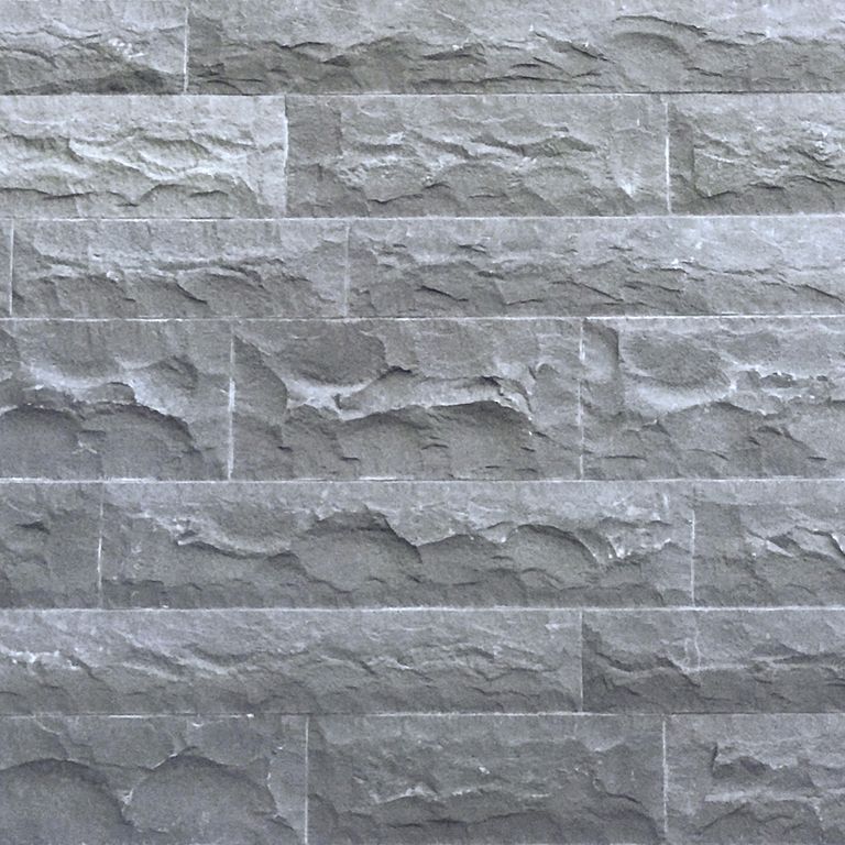 Close-up image for Ankar Gray Basalt - Split Veneer. The surface finish shown is split-face with rough plane. The dominant color shown is gray; with blue and white secondaries. Exhibits 