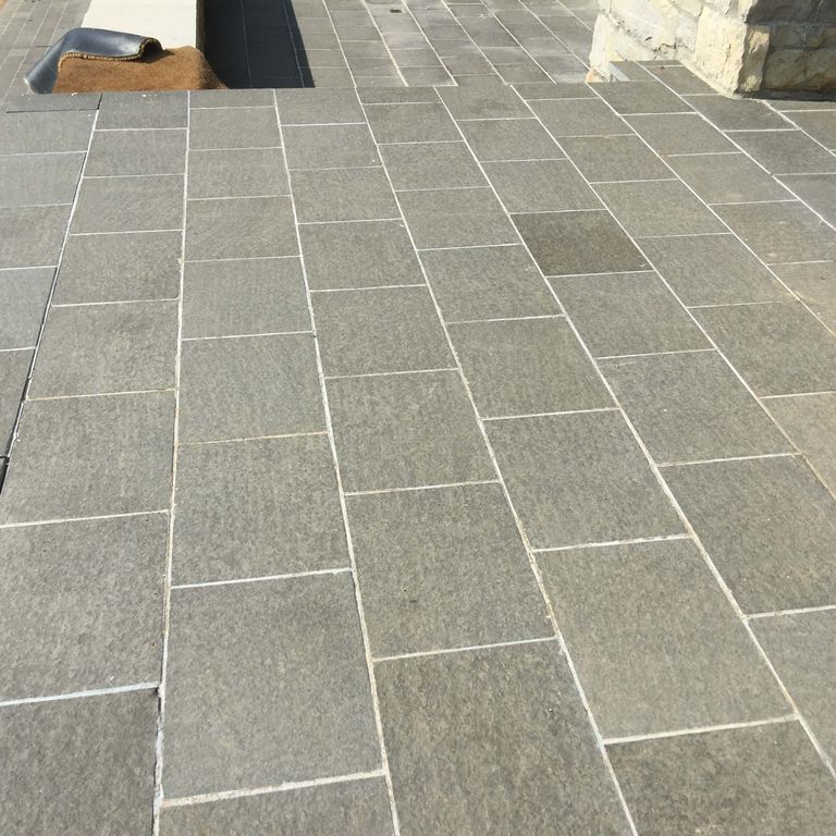 The image shows this product being used in a patio pavers application.