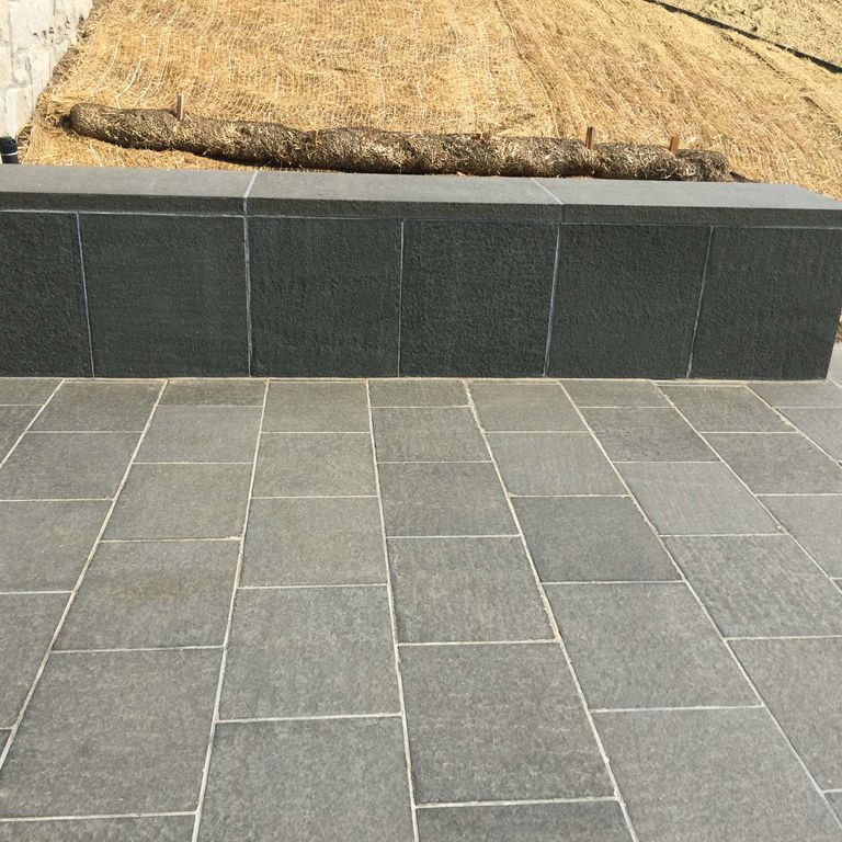 Application image for Basalt - Nordic Black - Dimensional Cut Pavers. The image shows this product being used in a patio pavers application. The dominant color shown is gray.