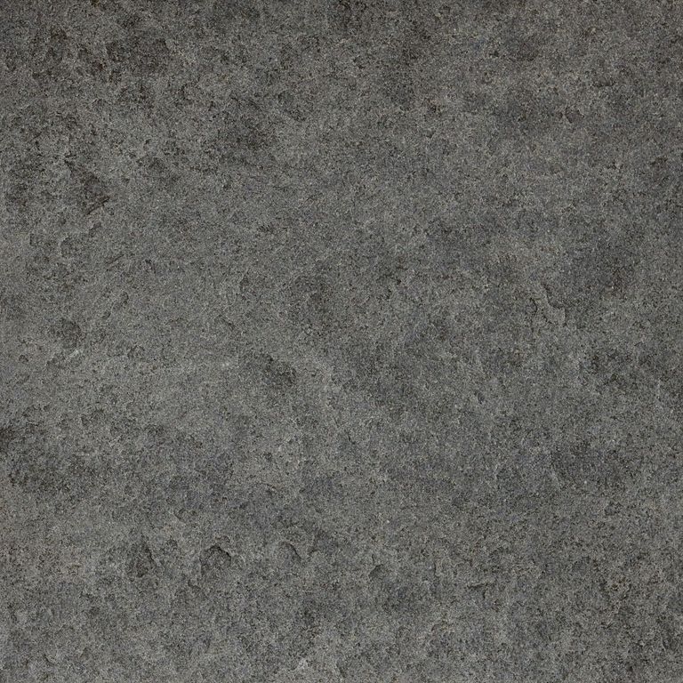 Color/Finish variation image for Ankar Black Basalt - Cobblestones. The surface finishes shown are brushed and flamed. The dominant color shown is gray; with black, brown, green and purple secondaries. The color mix creates a cool feeling. Blotched color pattern.