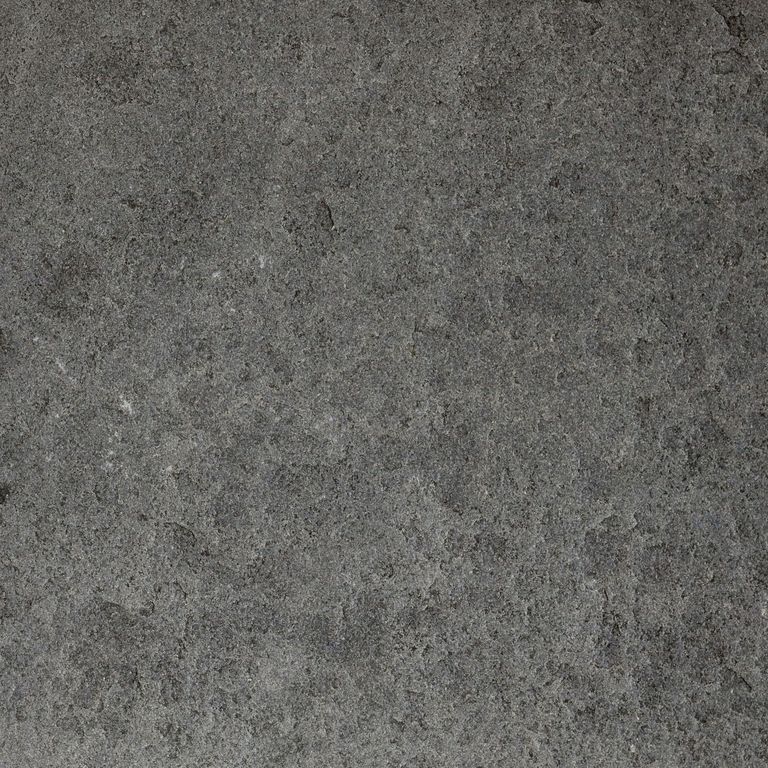Color/Finish variation image for Ankar Black Basalt - Cobblestones. The surface finishes shown are brushed and flamed. The dominant color shown is gray; with black, brown, green and purple secondaries. The color mix creates a cool feeling. Blotched and cloudy color patterns.