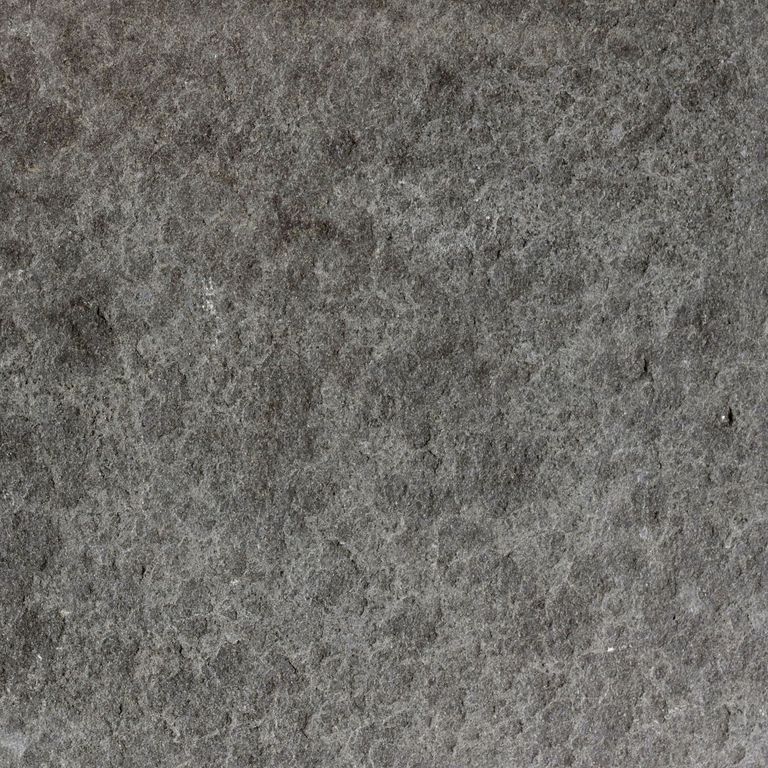 Color/Finish variation image for Ankar Black Basalt - Cobblestones. The surface finishes shown are flamed and waterjet. The dominant color shown is gray; with black, brown, green and purple secondaries. The color mix creates a cool feeling. Blotched and cloudy color patterns.