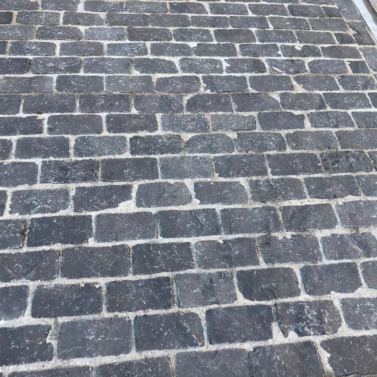 Close-up image for Ankar Black Basalt - Cobblestones. The surface finish shown is natural. The dominant color shown is gray; with blue and purple secondaries. The color mix creates a cool feeling. Regular color pattern.