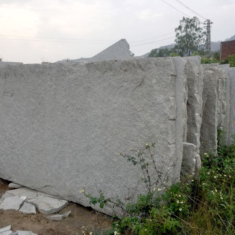 Feature image for Granite Quarry Skins - Oversized Pavers. The dominant color shown is gray. The color mix creates a cool feeling. Regular and fine speckled color patterns.