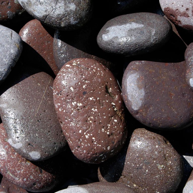 Feature image for Granite - Beach Pebbles - Natural Red. Dominant colors shown are brown, gray, purple and red. The color mix creates a warm feeling. Fine speckled and speckled color patterns.