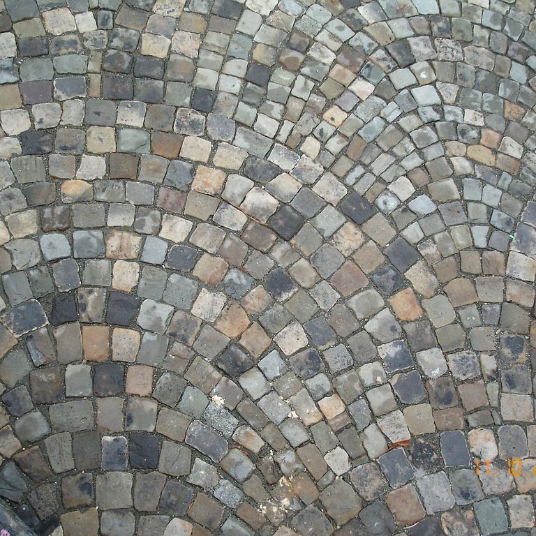 Application image for Reclaimed European Sandstone Cobblestones - Worn Cubes. The image shows this product being used for driveway pavers and patio pavers. The surface finish shown is . The dominant color shown is gray. The color mix creates a cool feeling.