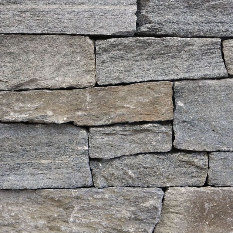 Feature image for Granite - Old Chester Veneer - End Grain Splitface. The surface finish shown is split-face. The dominant color shown is gray. Regular, linear and random color patterns.