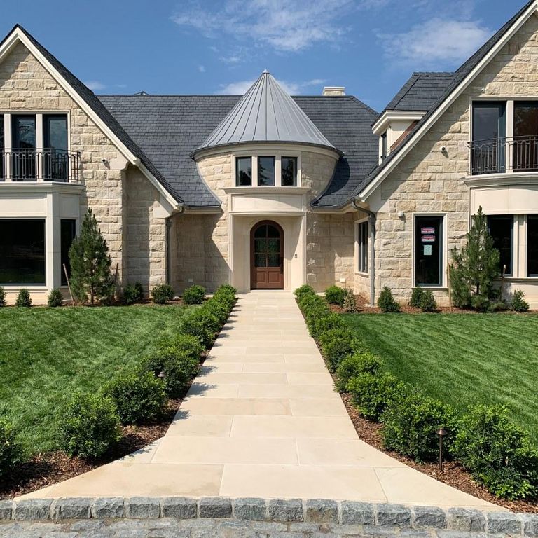 Feature image for Sandstone - Portland White - Pavers. The image shows this product being used in a path pavers application. Dominant colors shown are beige, tan and cream. The color mix creates a warm feeling. Solid color pattern.