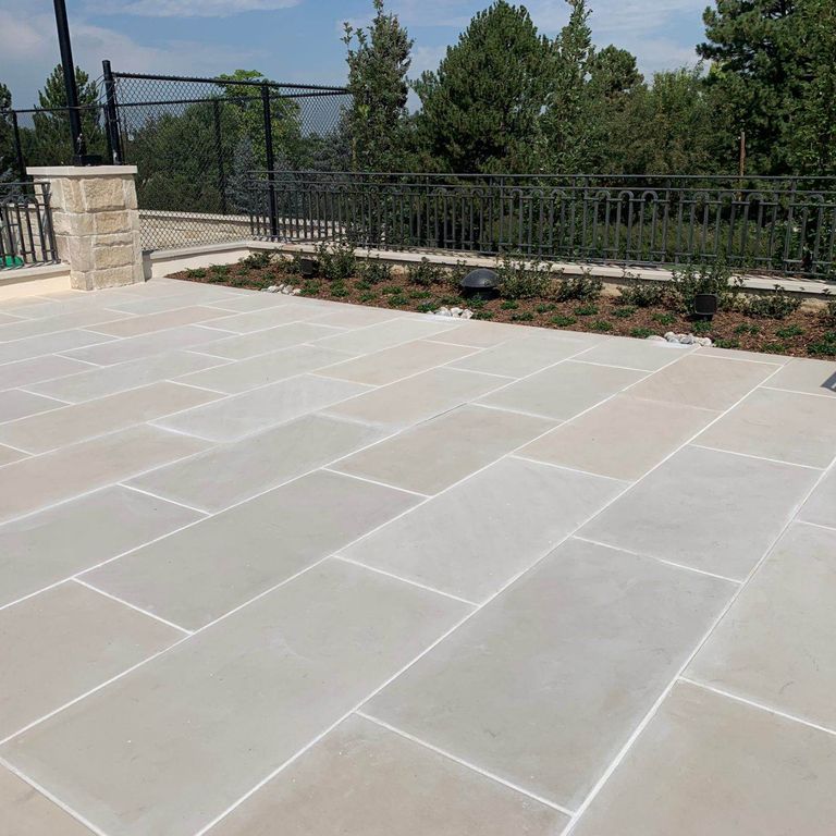 Application image for Sandstone - Portland White - Pavers. The image shows this product being used in a patio pavers application. The dominant color shown is beige.