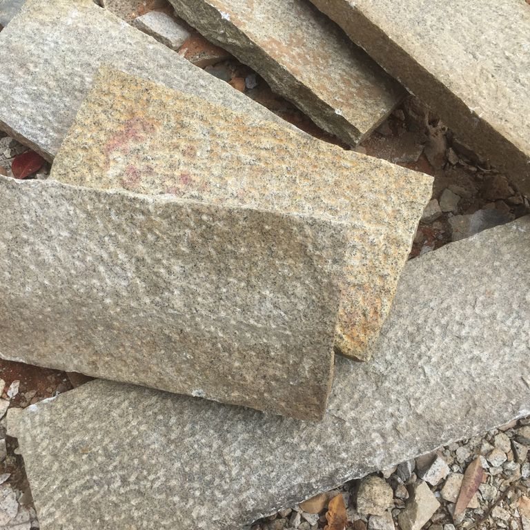 Close-up image for Granite - Antiqued Plank - Pavers. The surface finishes shown are antiqued and pineapple. Dominant colors shown are beige, brown, gray and tan; with orange/rust and cream secondaries. Exhibits 