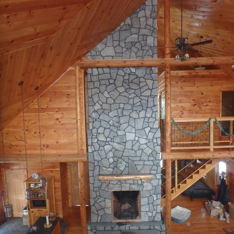 Application image for Granite - Greenwich Blue - Veneer. The image shows this product being used for fireplace surround, thin veneer and interior cladding. The dominant color shown is brown. The color mix creates a warm feeling.