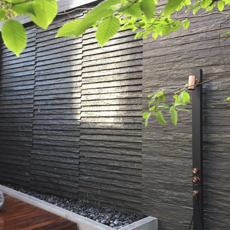 Application image for Black Schist - Wall Veneer. The image shows this product being used for full bed veneer and thin veneer. The surface finish shown is natural cleft. Dominant colors shown are black and gray. The color mix creates a cool feeling.