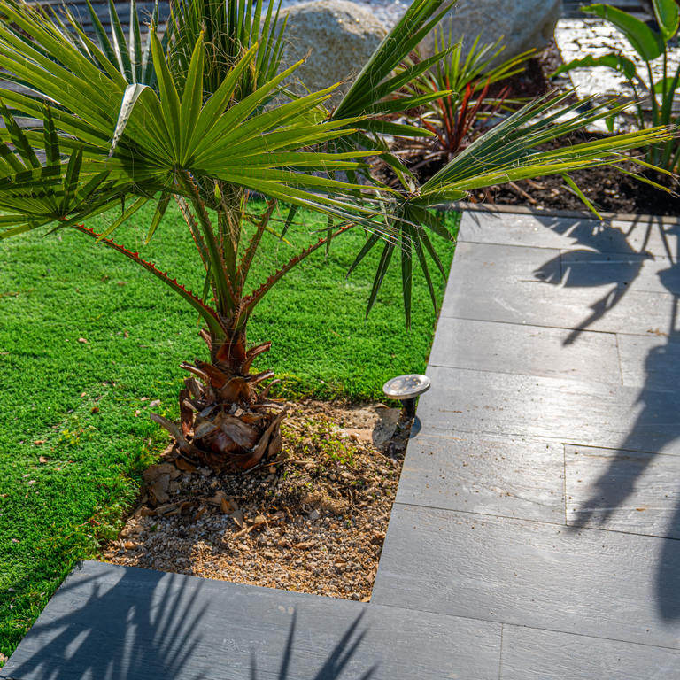Application image for Black Schist - Pavers. The image shows this product being used in a patio pavers application. The surface finish shown is brushed. The dominant color shown is gray. The color mix creates a warm feeling.