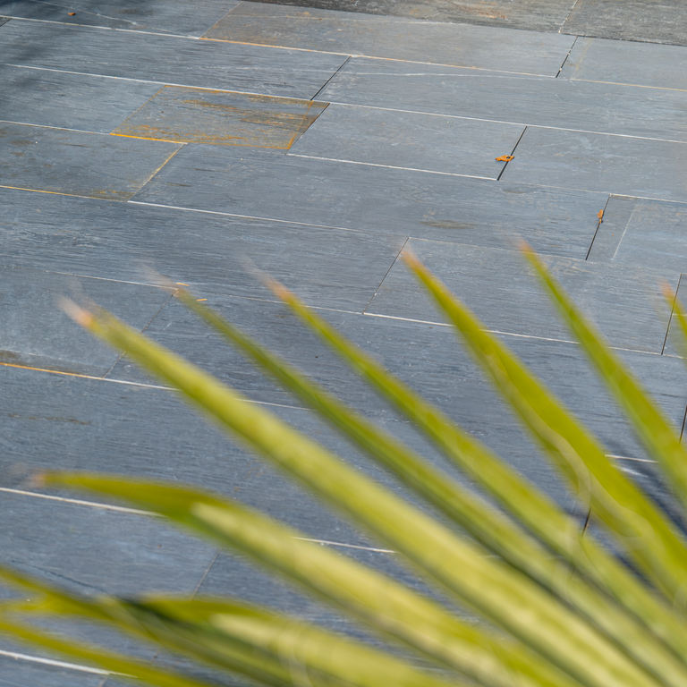 Application image for Black Schist - Pavers. The image shows this product being used in a patio pavers application. The dominant color shown is gray. The color mix creates a warm feeling.