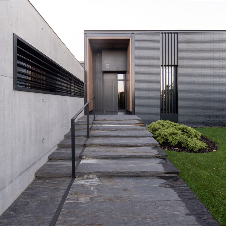 Application image for Black Schist - Pavers. The image shows this product being used for path pavers, landings and treads. The surface finish shown is natural cleft. Dominant colors shown are black and gray. The color mix creates a warm feeling.