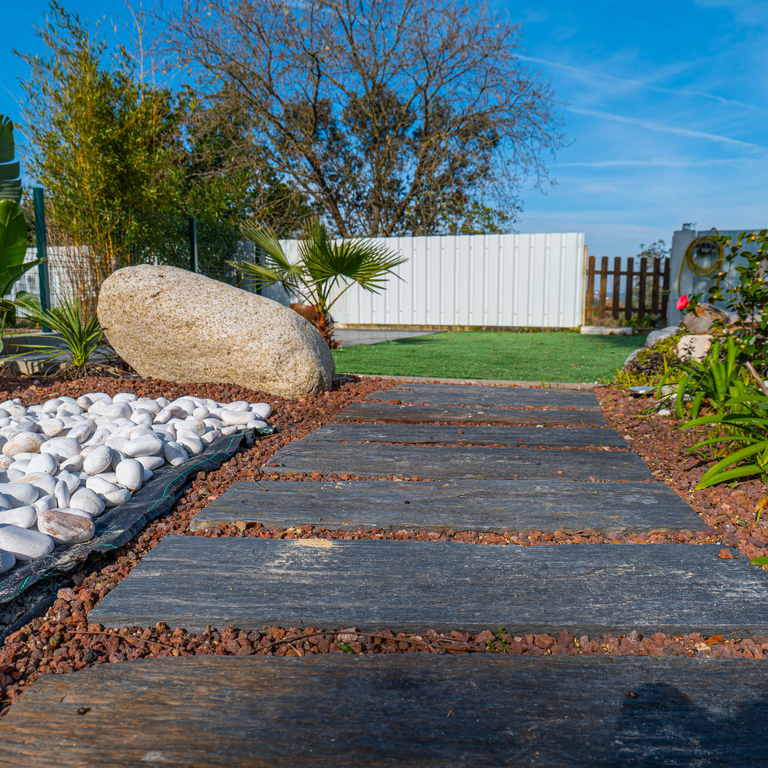 Application image for Black Schist - Pavers. The image shows this product being used in a path pavers application. The surface finish shown is natural cleft. The dominant color shown is gray. The color mix creates a cool feeling.