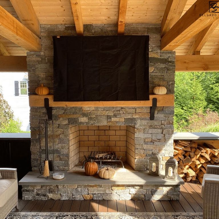 Feature image for Granite - Spruce Mountain- Veneer. The image shows this product being used for fireplace surround, full bed veneer and thin veneer. The surface finish shown is split-face. Dominant colors shown are gray, orange/rust and tan; with green, orange/rust, purple and tan secondaries. Exhibits 