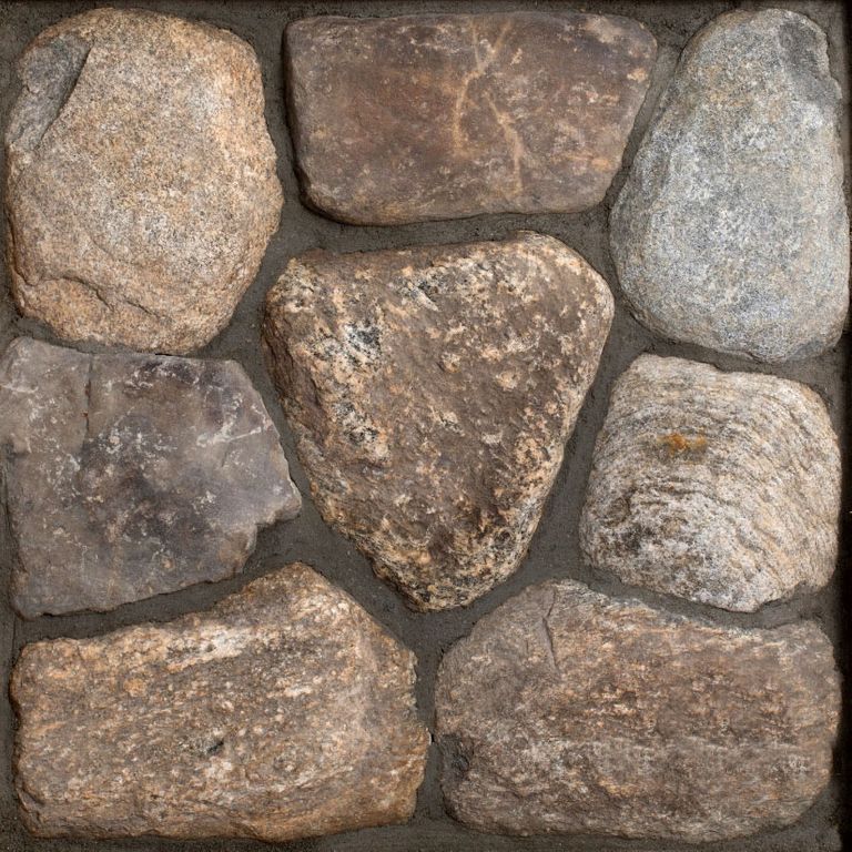 Best close-up image for Old New England Fieldstone Rounds - Thin Veneer. The surface finish shown is natural. Dominant colors shown are brown, gray and tan; with orange/rust, purple and tan secondaries. Exhibits 