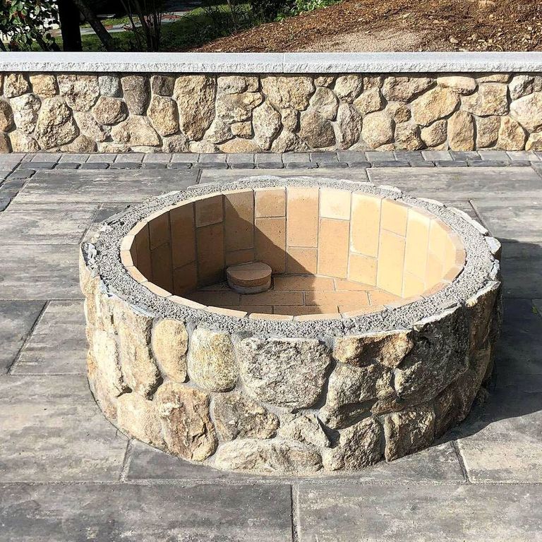Application image for Fieldstone - Old New England Rounds - Thin Veneer. The image shows this product being used for outdoor fire concepts, landscape wallstone and thin veneer. The surface finish shown is natural. Dominant colors shown are gray and tan. The color mix creates a warm feeling. Speckled and blotched color patterns.
