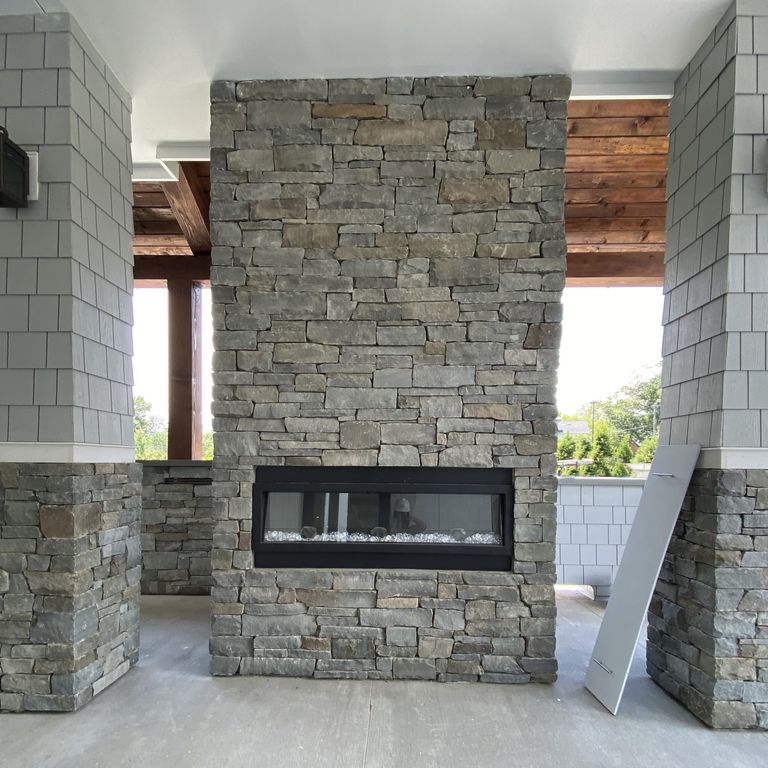 Feature image for Colonial Wall Granite - Wall Veneer. The image shows this product being used for full bed veneer and thin veneer. Dominant colors shown are green and gray; with beige, brown and purple secondaries. Exhibits 