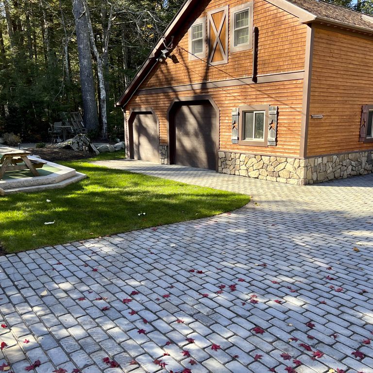 Application image for Bluestone Blue/Gray - Cobblestone Pavers. The image shows this product being used in a driveway pavers application. The surface finish shown is . Dominant colors shown are blue and gray. The color mix creates a cool feeling. Solid color pattern.