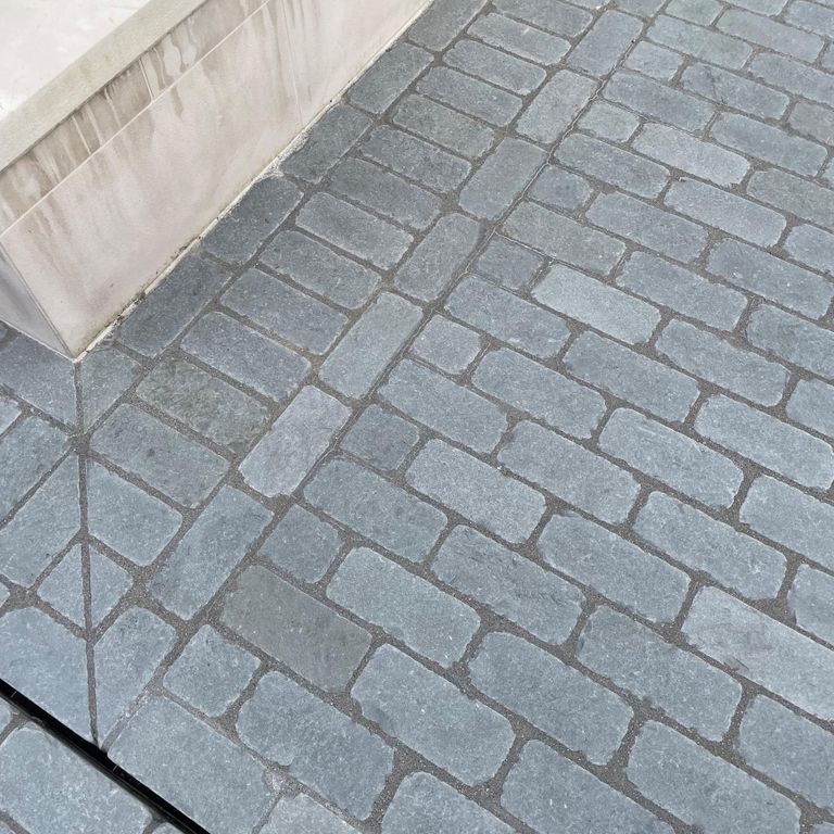 Application image for Bluestone Blue/Gray - Cobblestone Pavers. The image shows this product being used in a driveway pavers application. The surface finish shown is . Dominant colors shown are blue and gray. The color mix creates a cool feeling. Regular color pattern.