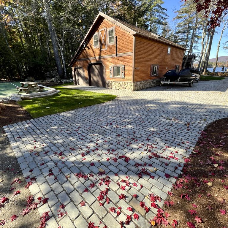 Application image for Bluestone Blue/Gray - Cobblestone Pavers. The image shows this product being used in a driveway pavers application. The surface finish shown is . The dominant color shown is gray. The color mix creates a cool feeling. Solid color pattern.