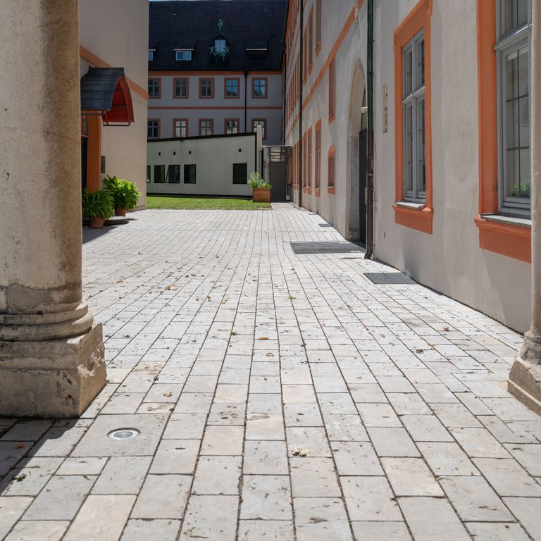 Application image for Bavarian Dolomite Gray Limestone - Cobblestones. The image shows this product being used in a path pavers application. Dominant colors shown are gray and tan. The color mix creates a warm feeling.