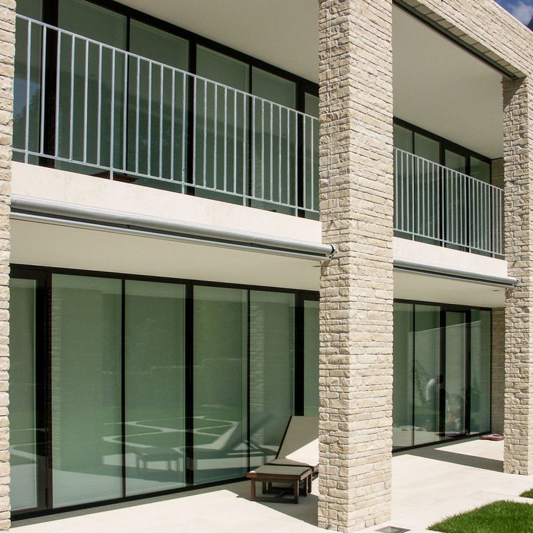 Application image for Bavarian Beige Limestone - Veneer. The image shows this product being used for full bed veneer and thin veneer. The surface finish shown is split-face. Dominant colors shown are beige and tan. The color mix creates a warm feeling.