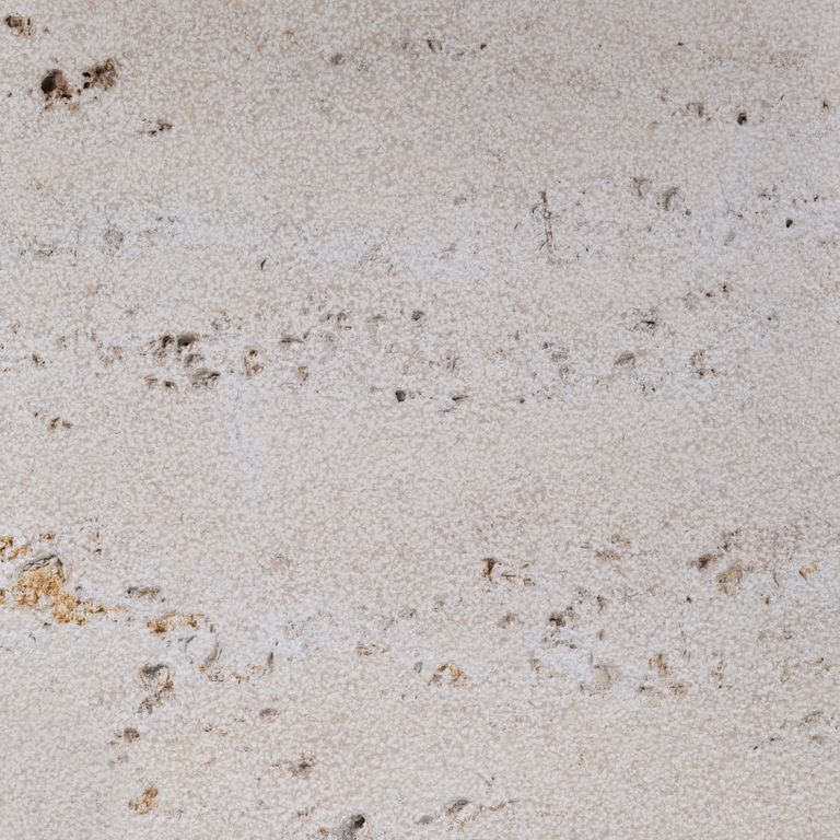 Color/Finish variation image for Bavarian Travertine - Beige - Wall Veneer. The surface finish shown is bush hammered. Dominant colors shown are beige and gray; with pink, purple and white secondaries. Exhibits 