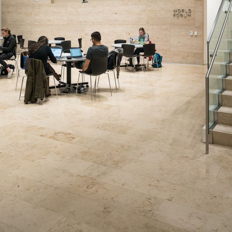 Feature image for Bavarian Travertine - Beige - Interior Floor. The image shows this product being used in an interior floor application. Dominant colors shown are beige and tan; with brown, orange/rust and cream secondaries. Exhibits 