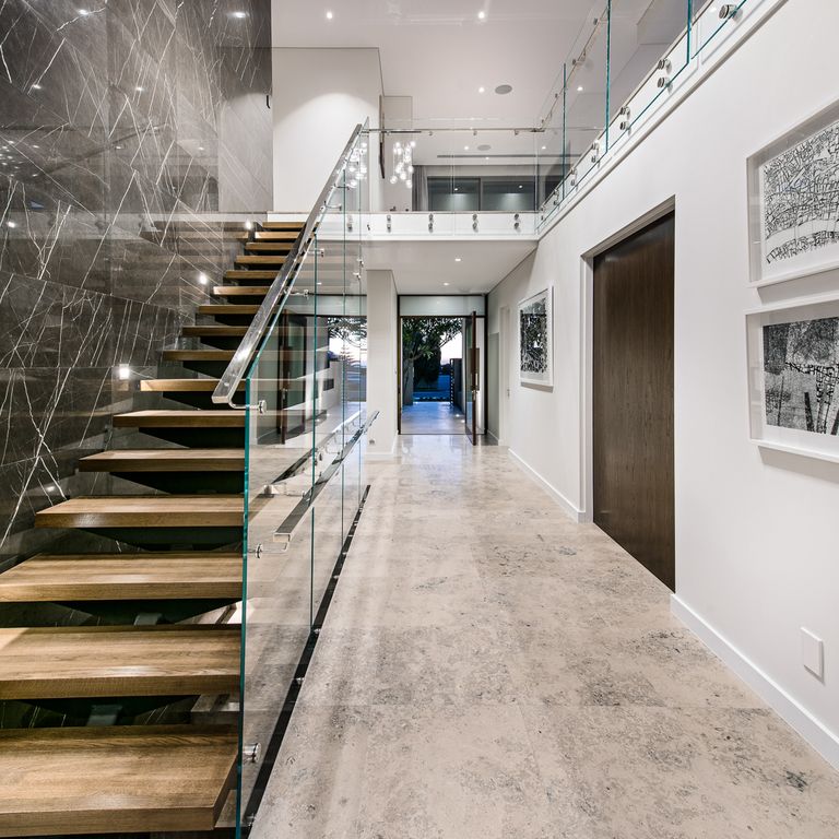 Best close-up image for Bavarian Gray Limestone - Interior Floor. The image shows this product being used in an interior floor application. The surface finish shown is honed. The dominant color shown is gray; with beige, orange/rust and white secondaries. Cloudy color pattern. Contains mineral inclusions.