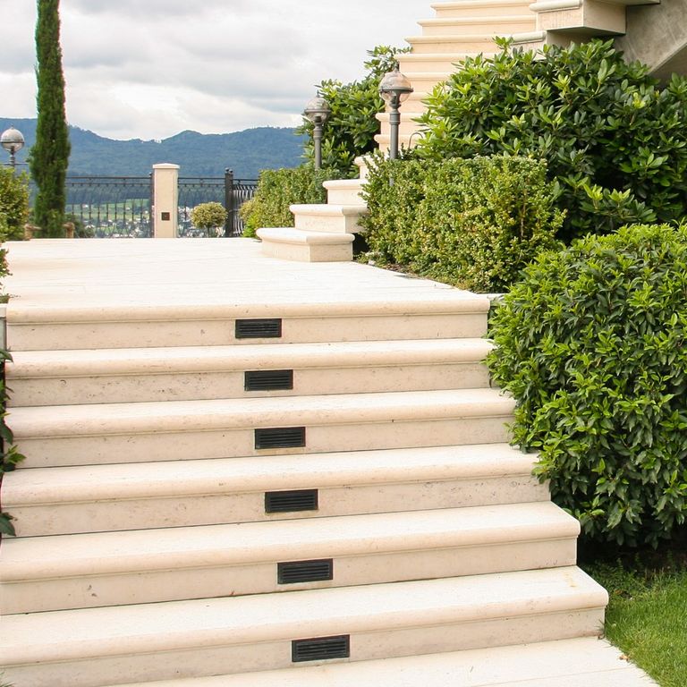 Close-up image for Bavarian Limestone Gala - Beige - Treads. The surface finish shown is honed. Dominant colors shown are beige and cream; with a white secondary. The color mix creates a warm feeling. Solid and cloudy color patterns. Contains mineral inclusions.