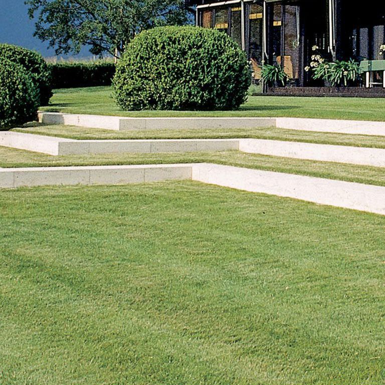 Application image for Bavarian Beige Limestone - Steps & Treads. The image shows this product being used in a monolithic steps application. Dominant colors shown are white and cream; with a beige secondary. The color mix creates a cool feeling. Fine speckled color pattern. Contains mineral inclusions.
