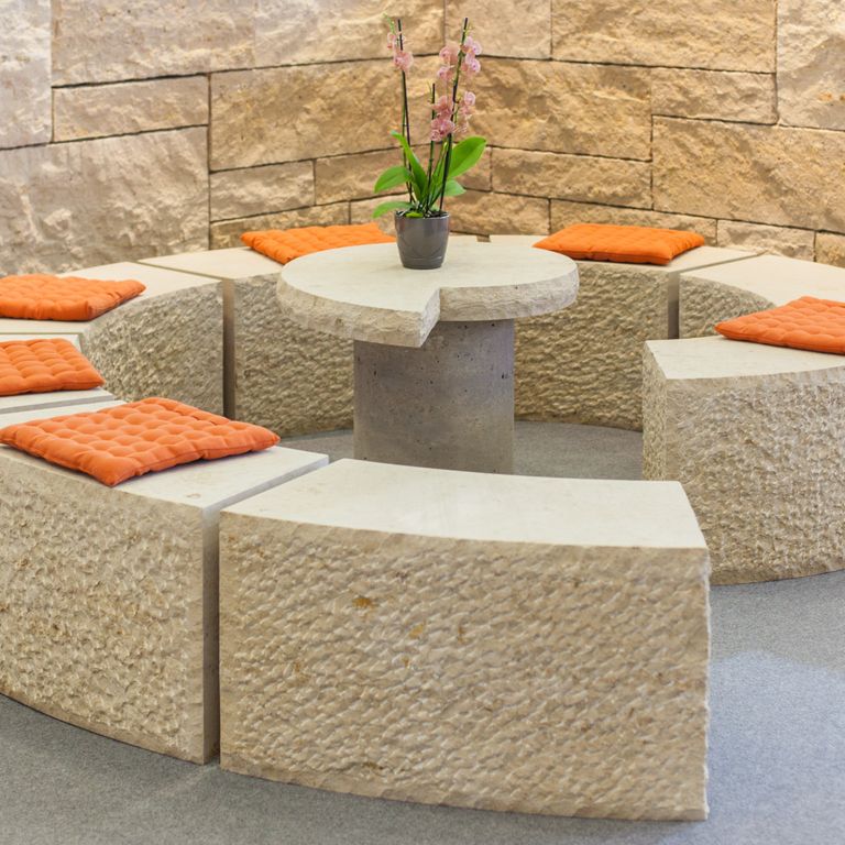 Feature image for Bavarian Limestone Gala - Beige - Benches & Seating. The image shows this product being used in a seating & benches application. Dominant colors shown are beige and tan; with brown, orange/rust and cream secondaries. The color mix creates a warm feeling. Regular and coarse speckled color patterns. Contains mineral inclusions.