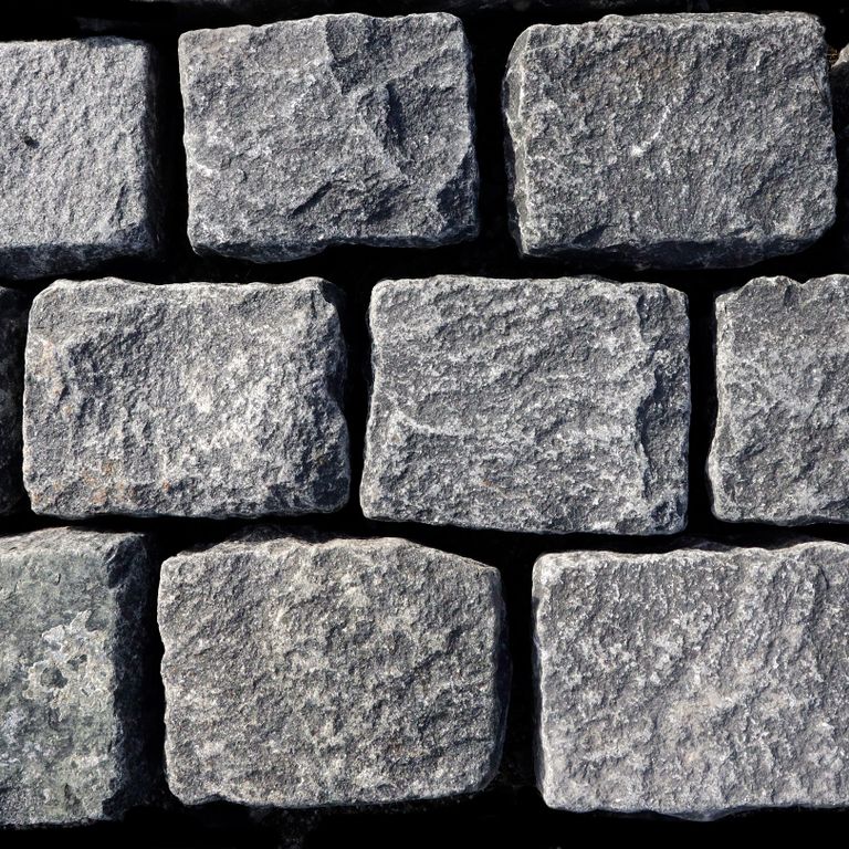 Feature image for Black Granite Cobblestones - Rectangles. The surface finish shown is split-face with flat plane. The dominant color shown is gray; with blue, green and white secondaries. Exhibits 