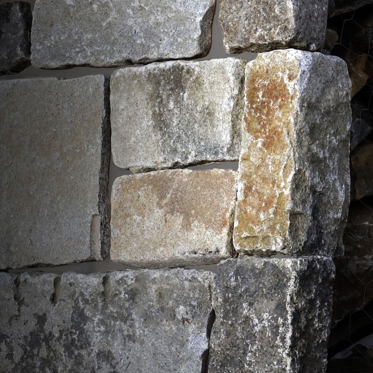 Best close-up image for Reclaimed Granite Thin Veneer Corners. The surface finish shown is . The dominant color shown is gray; with beige, brown, orange/rust, purple, white and tan secondaries. Exhibits 