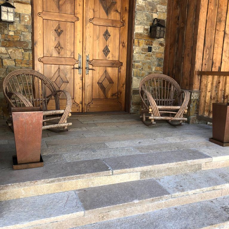 Feature image for Granite- Reclaimed Footworn Steps - Treads. The image shows this product being used in a treads application. The dominant color shown is gray; with blue, purple and white secondaries. The color mix creates a cool feeling. Speckled, blotched and cloudy color patterns.