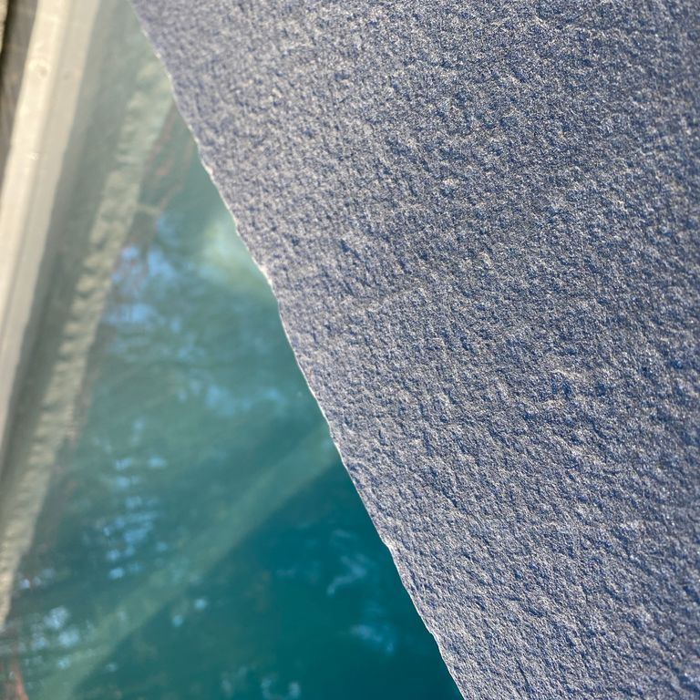 The image shows this product being used for Blue/Gray Bluestone - Flamed Pool Coping.