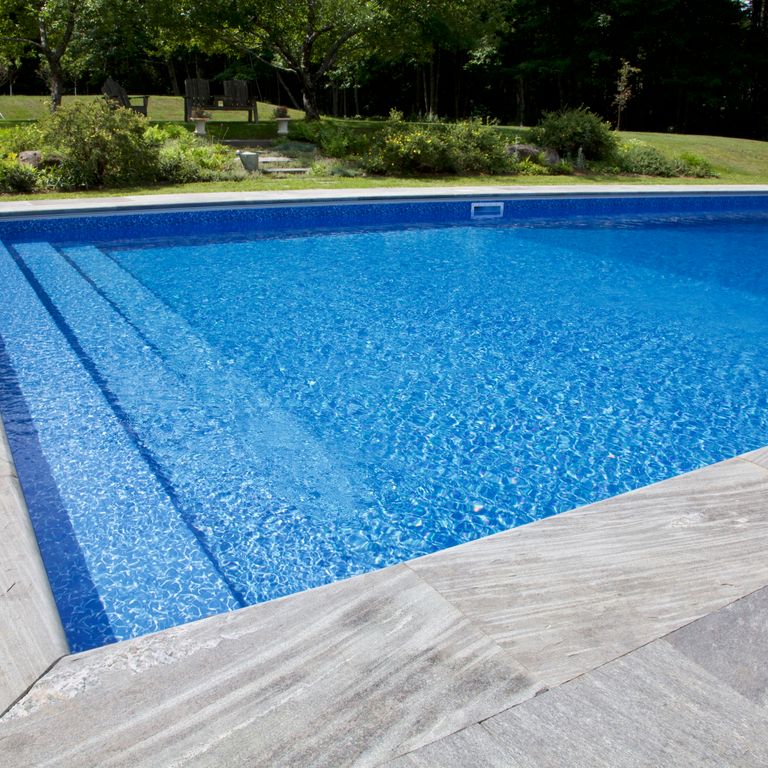 Feature image for Mystic Mountain Pool Coping. The image shows this product being used for pool coping, patio pavers and pool deck pavers. The design pattern shown is irregular flagging sawn flat edges & irregular sawn edges. The dominant color shown is gray; with a white secondary. Exhibits 