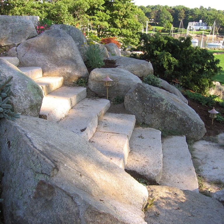 Application image for New England Fieldstone Boulders & Ledgestone - Jumbo Boulders. The image shows this product being used for garden accents and landscape boulders & ledge. The surface finish shown is weathered. The dominant color shown is gray. The color mix creates a warm feeling.