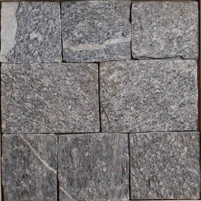 Close-up image for Bergen Blend Granite - Veneer. The surface finishes shown are natural and split-face with flat plane. The dominant color shown is gray; with brown, green and purple secondaries. Exhibits 
