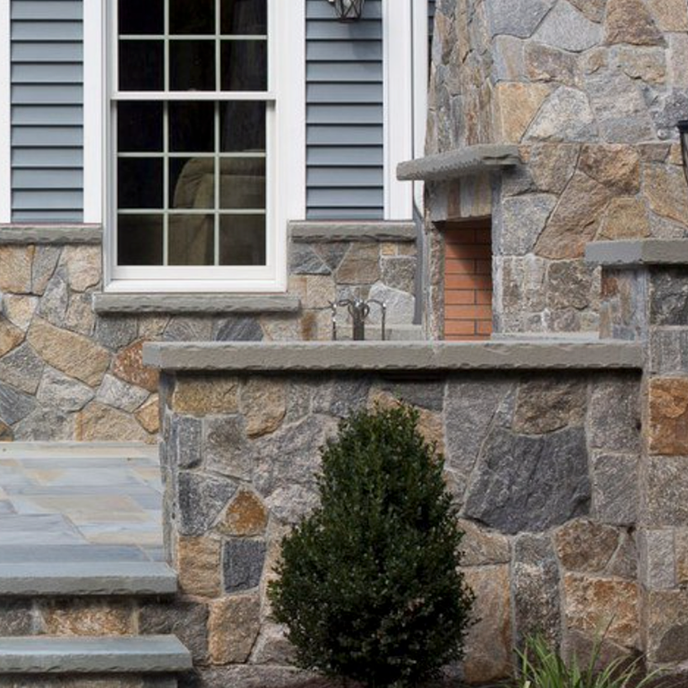 Feature image for Montauk Blend - Veneer. The image shows this product being used for full bed veneer and thin veneer. Dominant colors shown are brown and gray; with beige, orange/rust, tan and cream secondaries. Regular, random, speckled and blotched color patterns.
